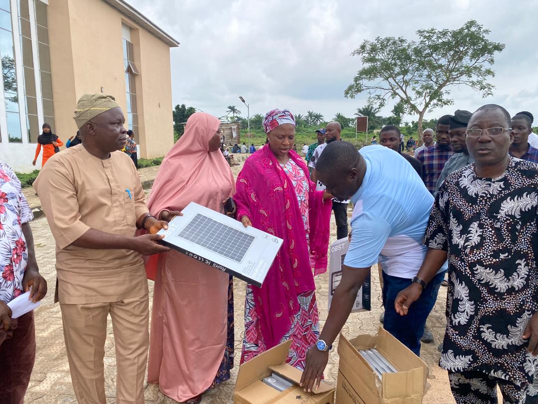 Community members discussing solar lights outside a public building