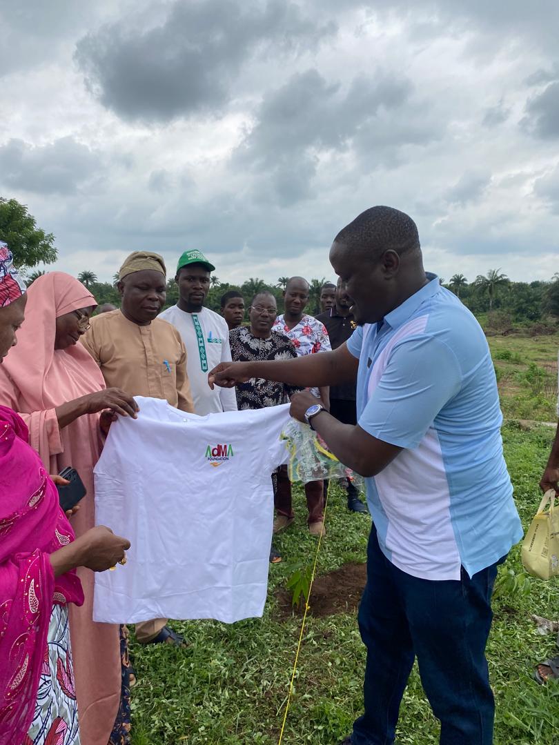 A Foundation representative showing an AdMA T-shirt to community members